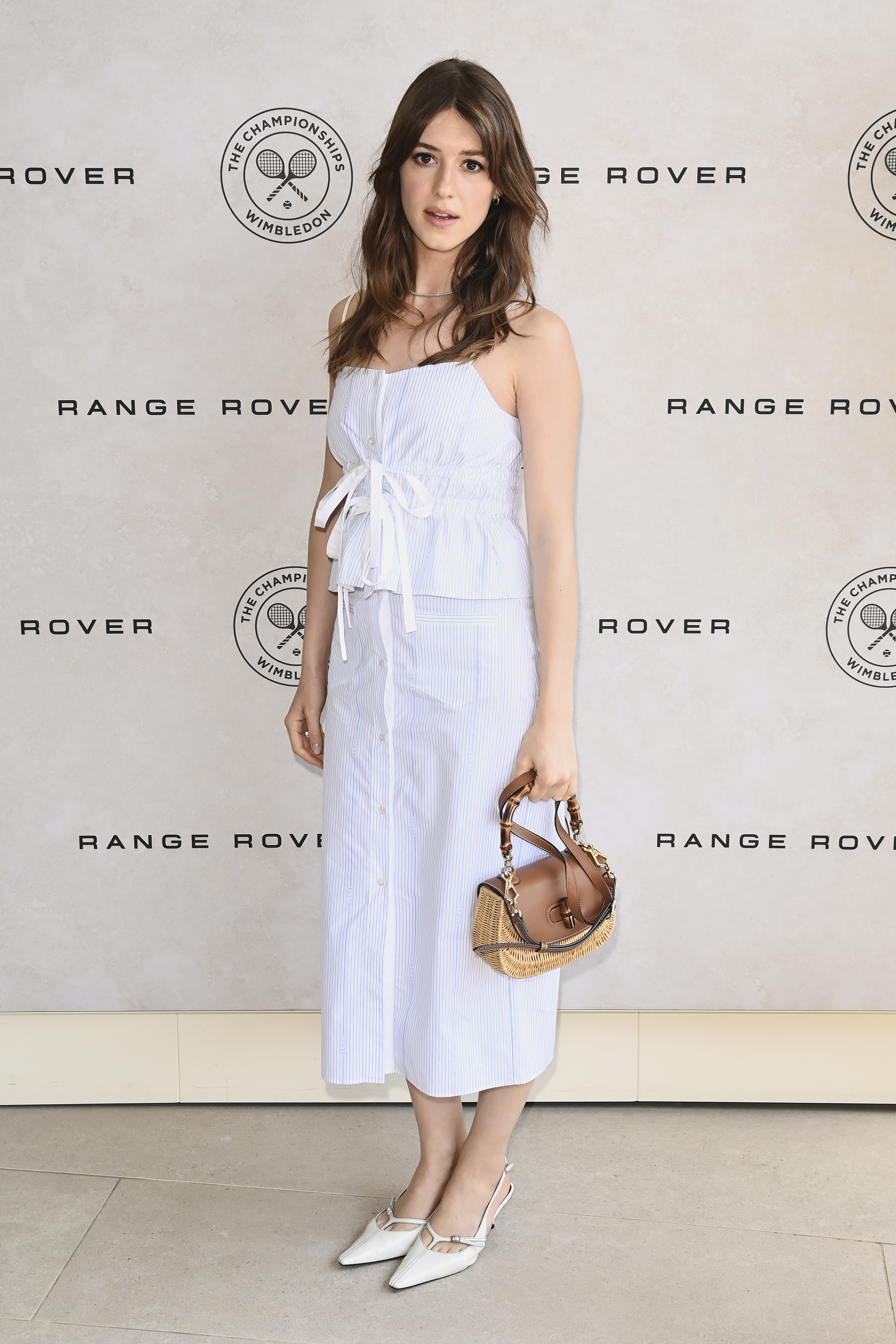 Daisy Edgar wears a matching linen set and carries a Gucci straw bag at Wimbledon
