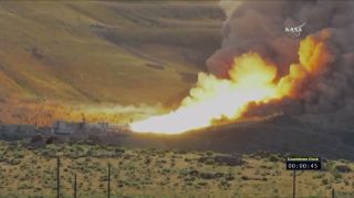 A view of the fire and smoke emerging from NASA's SLS rocket booster engine, which underwent a test firing on June 28, 2016.