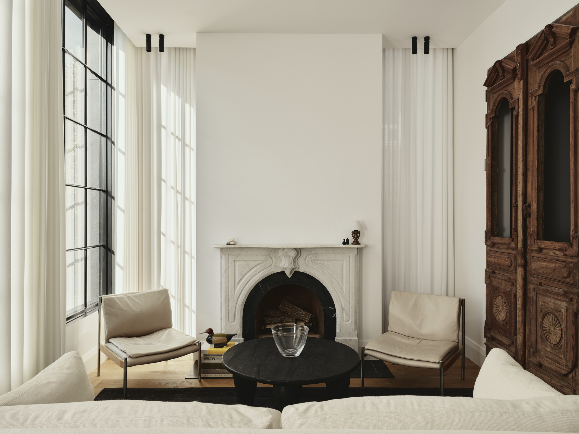 A small living room with recessed curtains