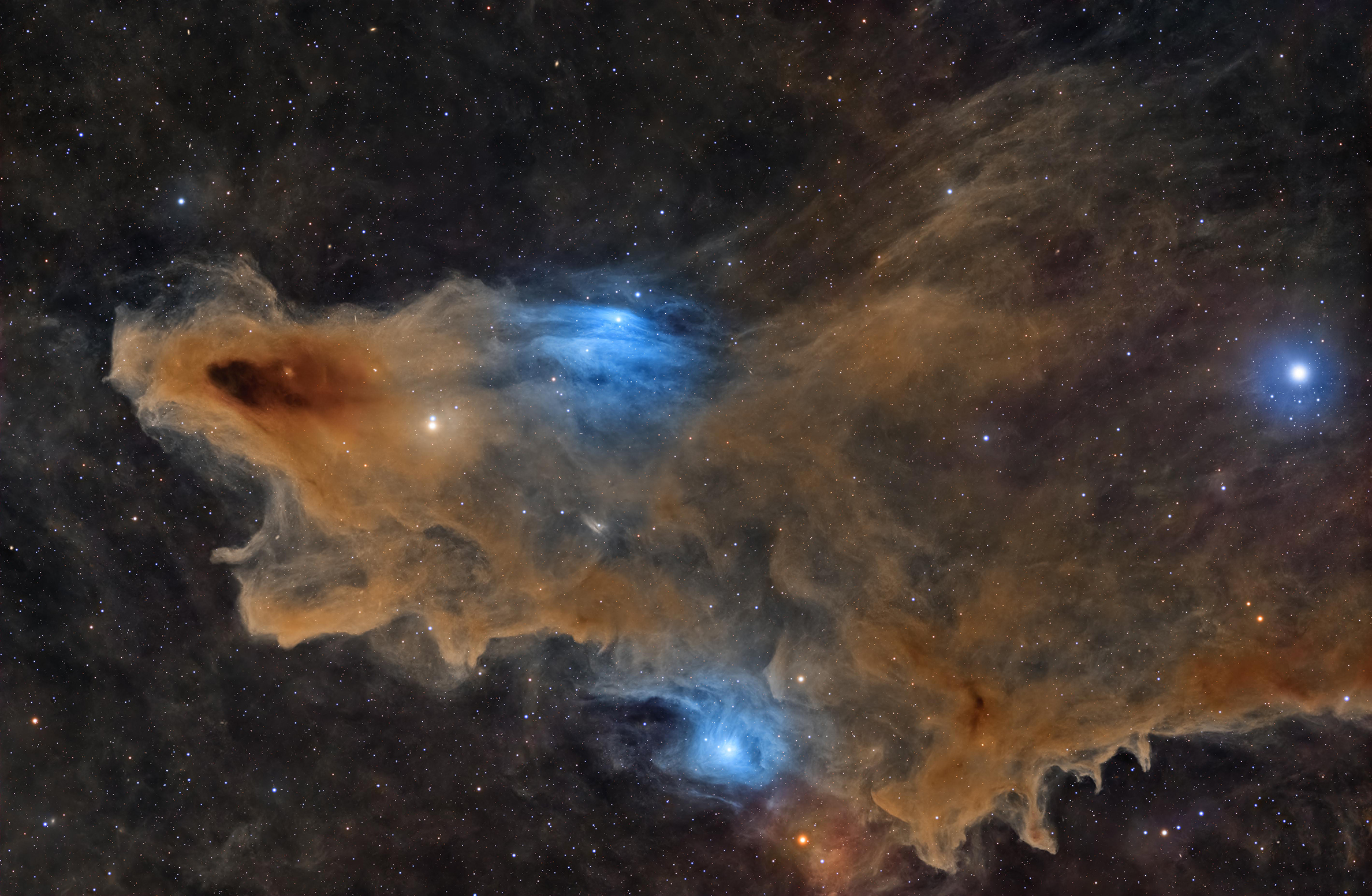 Colorful nebula with dense orange and blue gas clouds surrounding bright stars in deep space