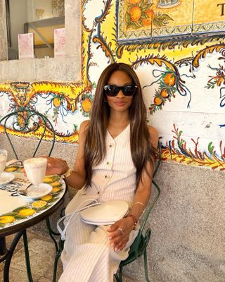 Woman wears striped linen waistcoat and trousers