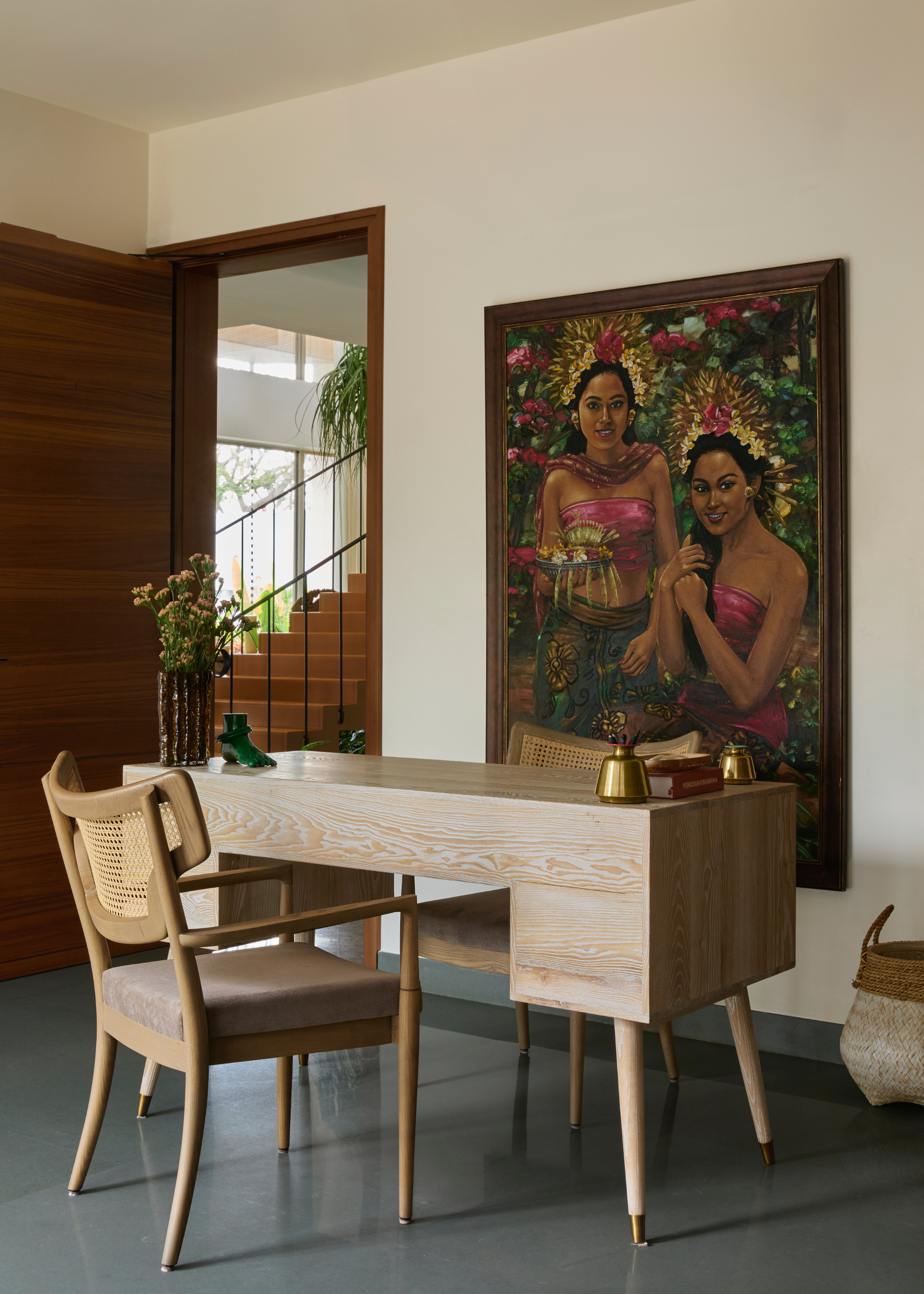 A beautiful study with colorful wall art and minimalist wooden furniture