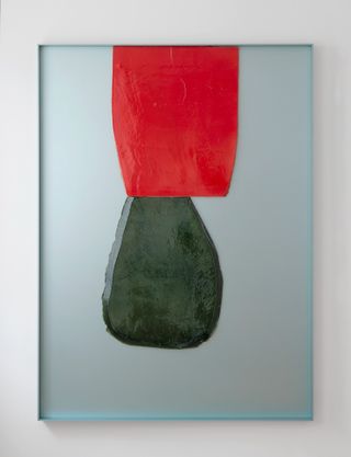 A ceramic bas-relief featuring green and red abstract forms on light blue aluminium background
