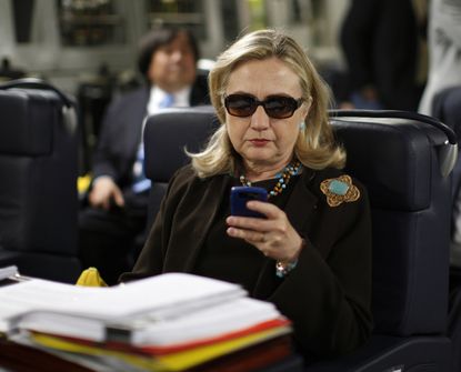 Hillary Clinton uses her Blackberry