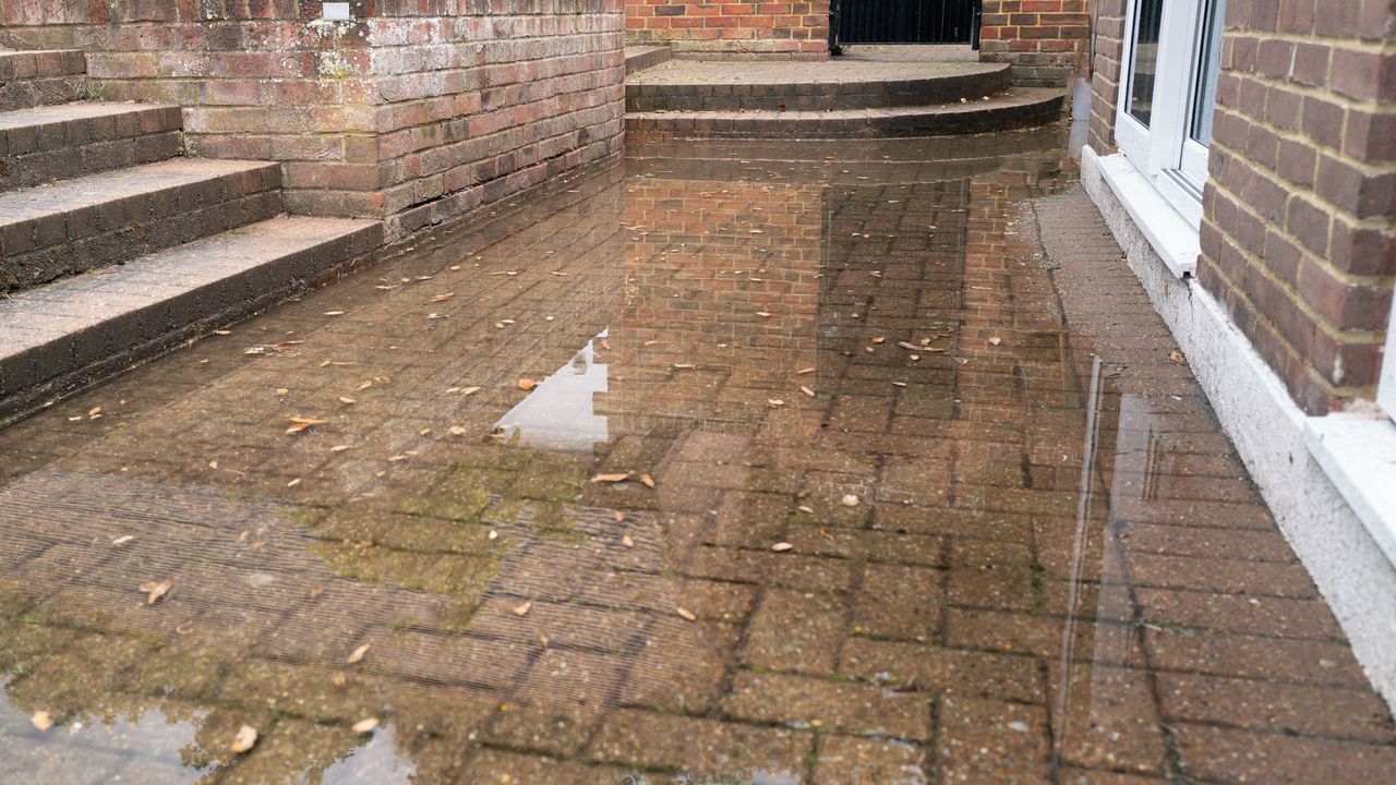 Rainwater accumulating on patio due to a blocked soakaway