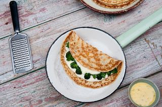 Savoury pancakes with cheese sauce and broccoli