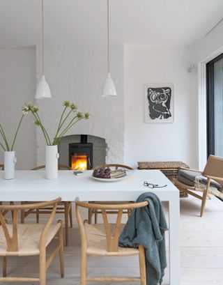White dining room with log burner