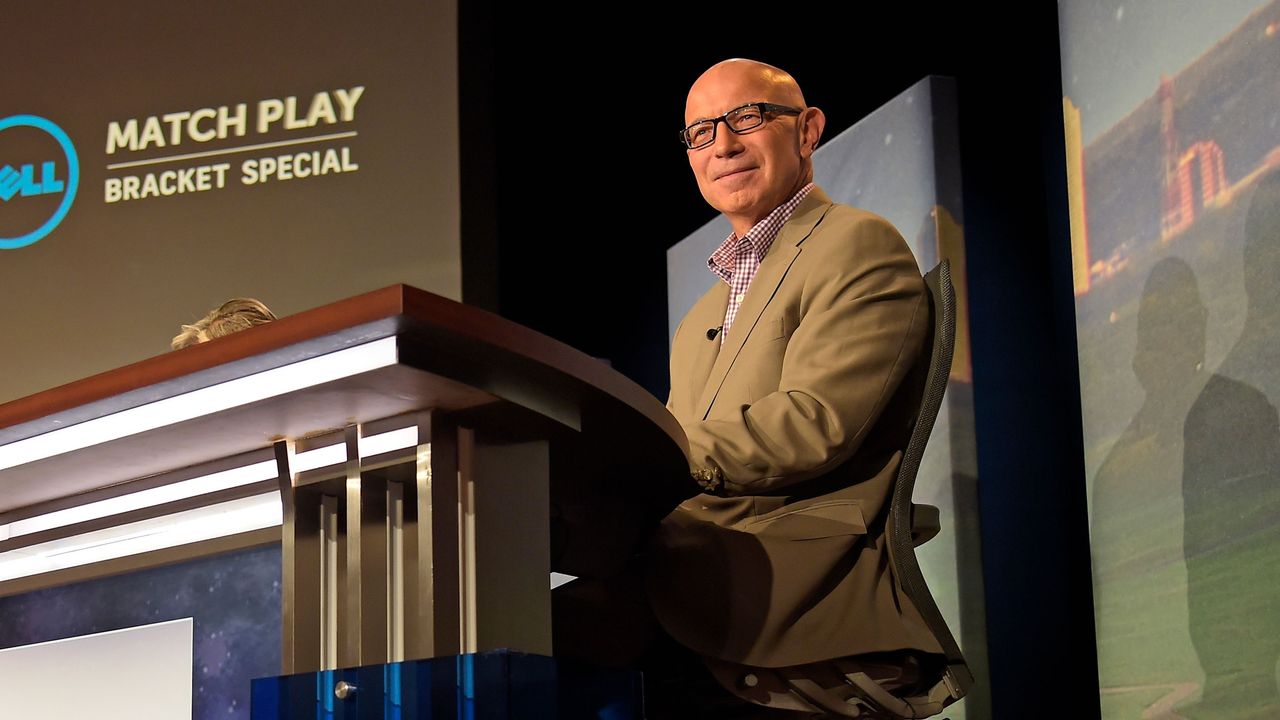 Tim Rosaforte sitting behind a desk on tv