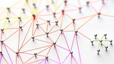 An abstract image of pins on a board connected by strings, representing a network