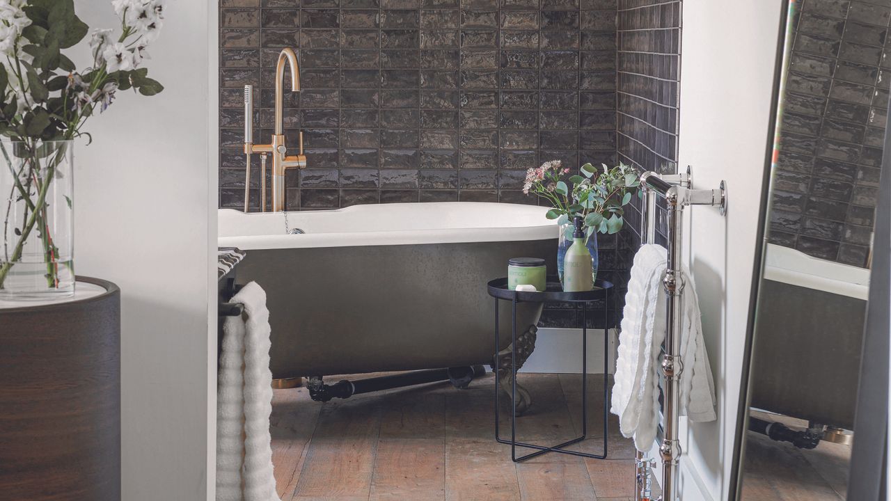 Modern bathroom with black bath and matching tiles