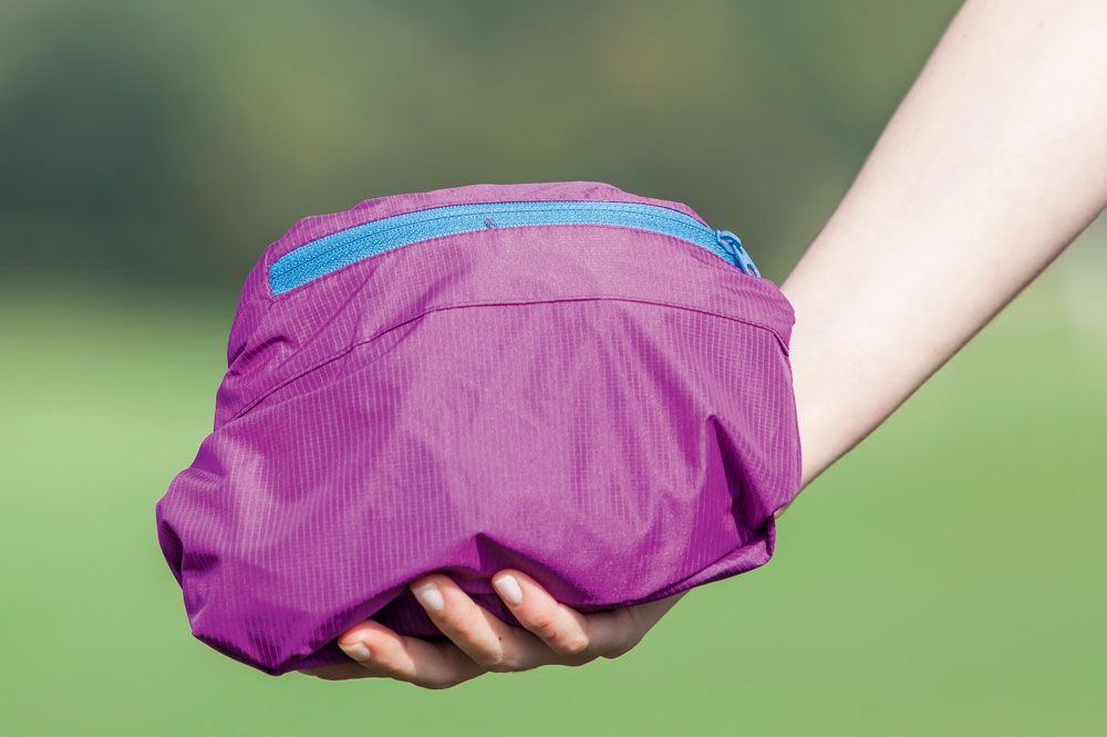 A purple gilet packed down into its own pocket