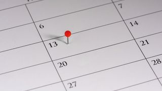 a calendar with a pin on friday 13