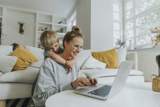 Woman learning how to make a school appeal on her laptop at home