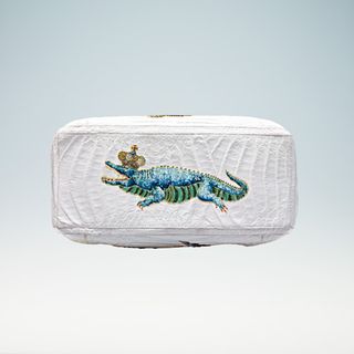 Base of white bag with a blue crocodile wearing a gold crown