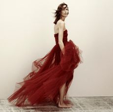 Woman in a red gown from H&M Studio Holiday Collection 2023