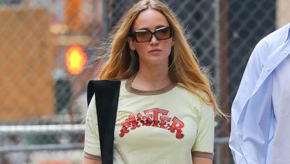Jennifer Lawrence wearing a vintage ringer tee and Tory Burch flats while walking in New York City