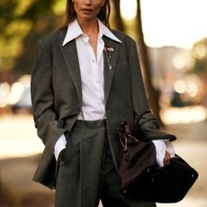 woman wearing grey suit, white button down shirt