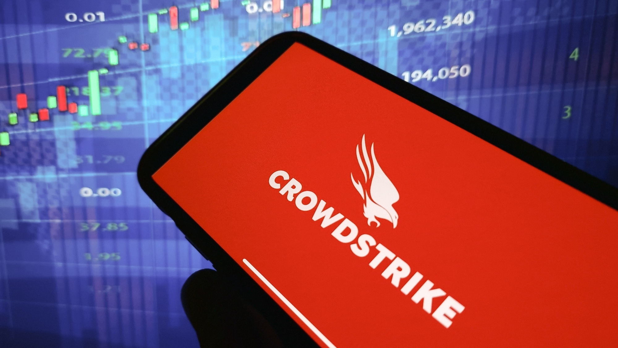 Crowdstrike logo in red on a smartphone against a blue background