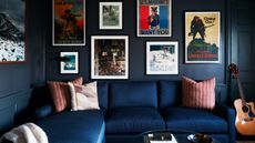 Indigo blue living room with matching sectional, artwork on walls, floor lamp