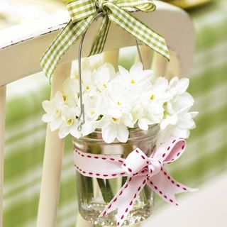 hanging jar with white flowers and ribbons on it