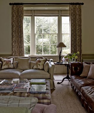 Neutral room, assorted sofas, sash window, gilded mirror