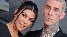 travis barker and kourtney kardashian on a gray background