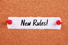Text says: "New Rules!" and is written on note paper pinned to a corkboard.