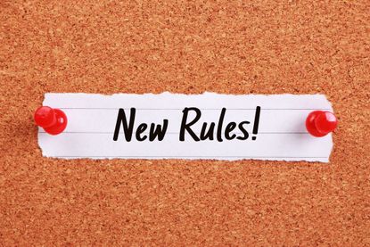 Text says: "New Rules!" and is written on note paper pinned to a corkboard.