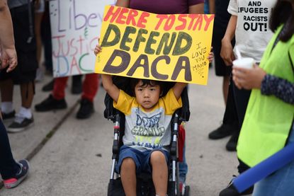  young boy holds a sign during a protest September 10, 2017 in Los Angeles, California against efforts by the Trump administration to phase out DACA.