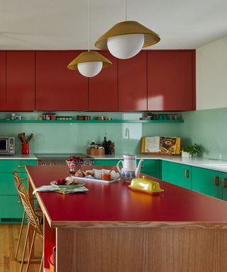 kitchen countertop trends, red and green retro style kitchen, vinyl on kitchen island, pale green glass backsplash, retro pendants