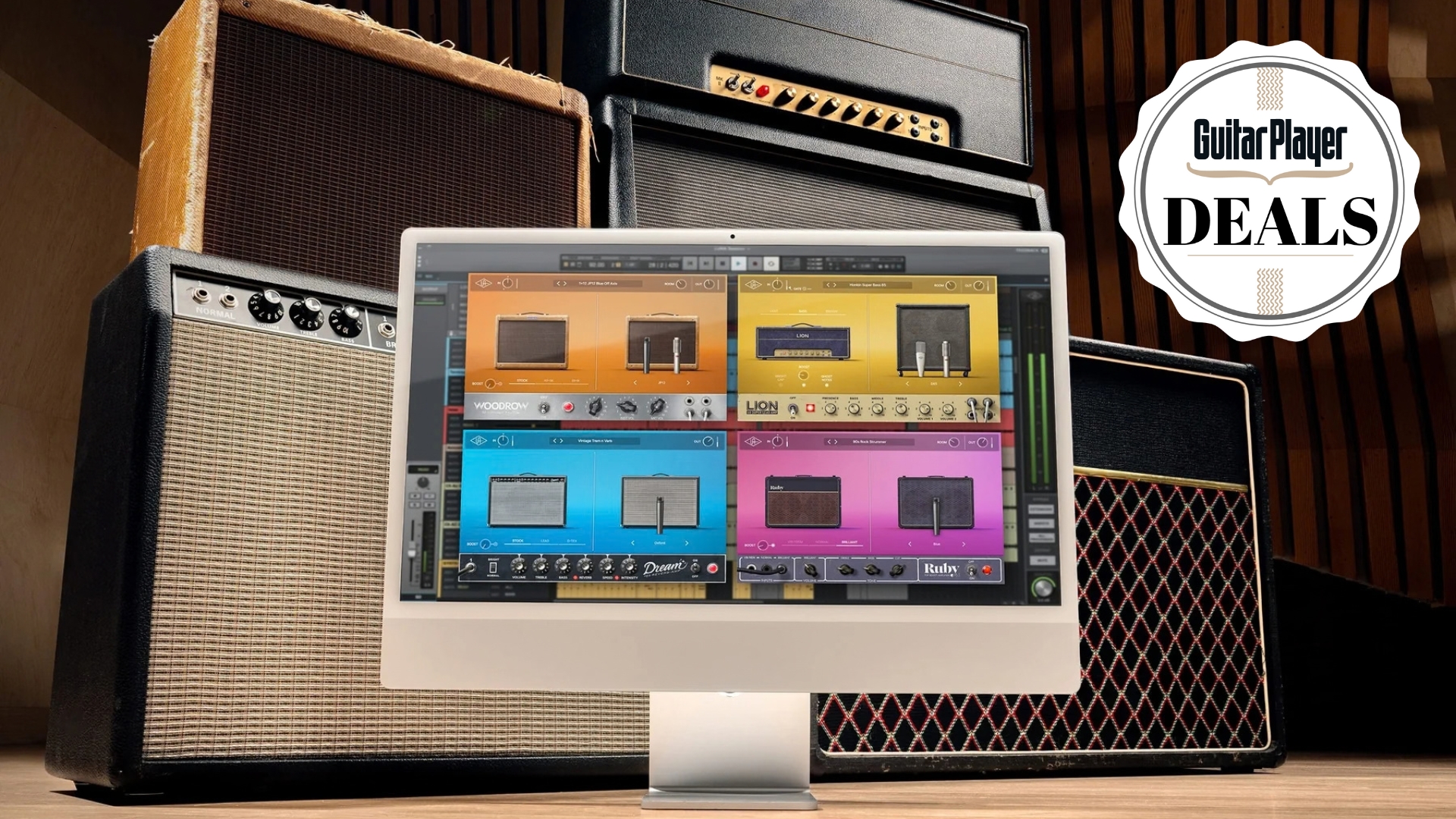 An iMac displaying guitar amp simulators in front of various guitar amplifiers