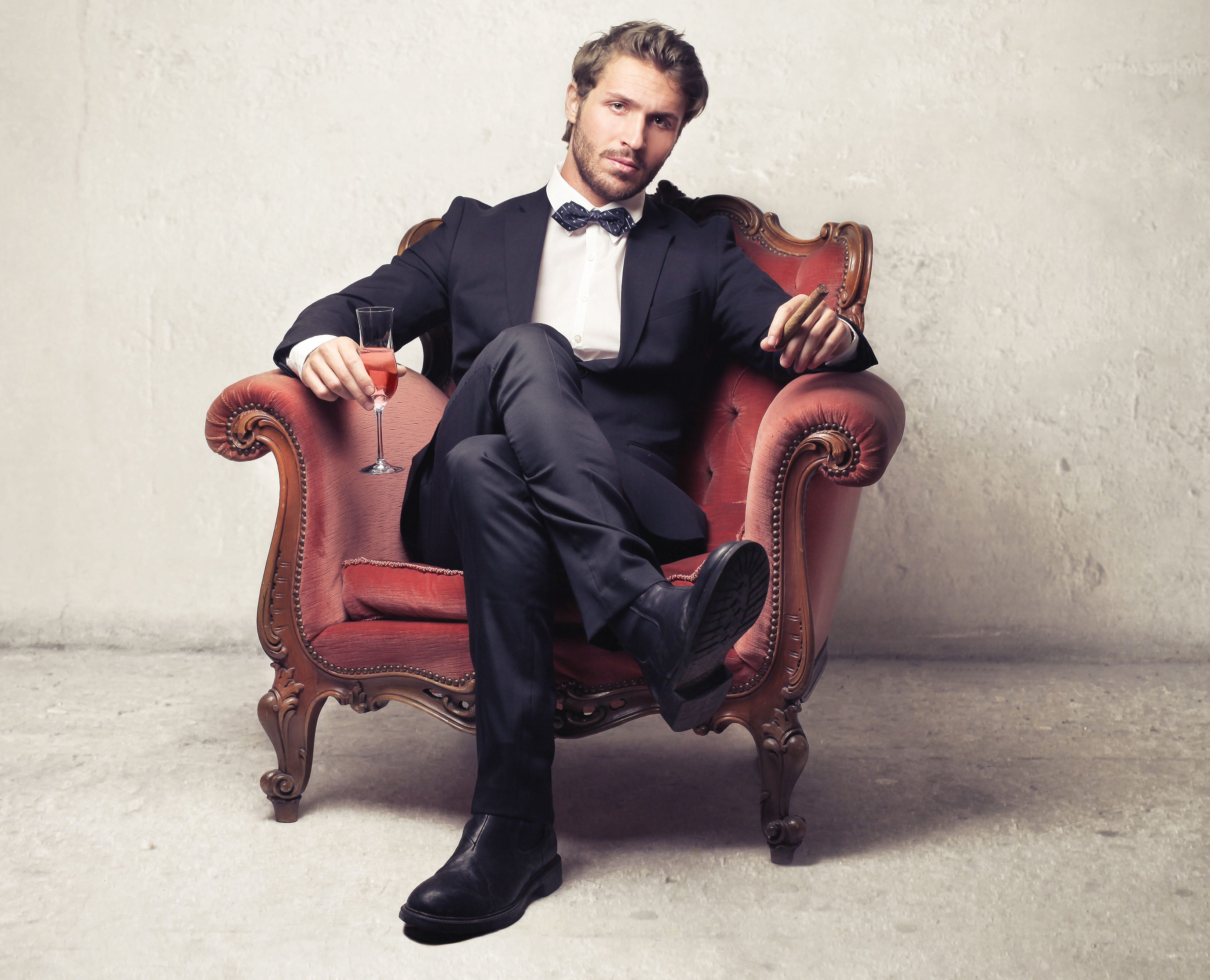 Gentleman sitting on a vintage armchair