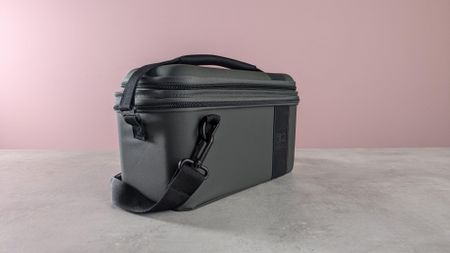 Three-quarter view of Turtle Beach PlayTrek 2-in-1 Case for Nintendo Switch 2 on a desk with pink wall in background