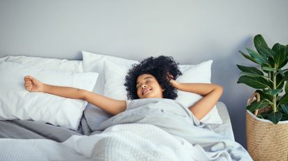 woman stretching after learning how to wake up early