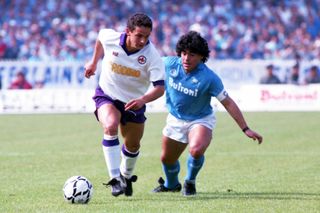 Roberto Baggio controls the ball under pressure from Diego Maradona in a game between Fiorentina and Napoli in 1987.