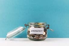 emergency fund glass jar on blue color background