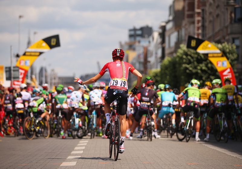 Tim Wellens practices his dance moves on his way to the start line