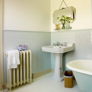 bathroom with white walls and tiles and white bathtub