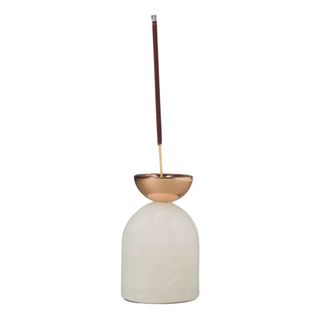 Alabaster and brass incense stick holder with a burning incense stick