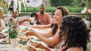 group laughing around dinner table