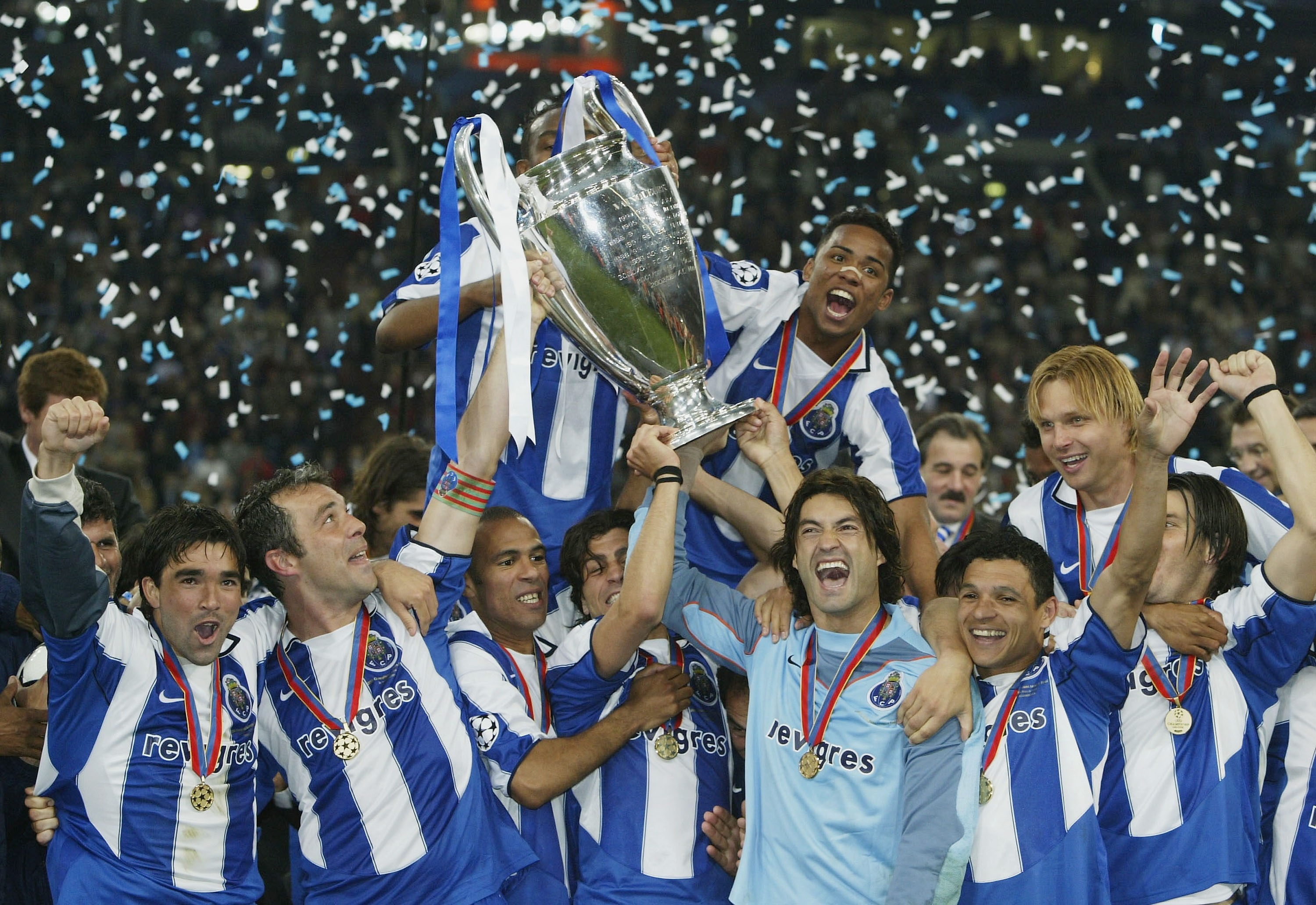 Porto players celebrate with the European Cup after victory over Monaco in the 2004 Champions League final in Gelsenkirchen.