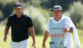 Shinkwin walks with his caddie