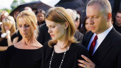 Photo of grieving family at graveside