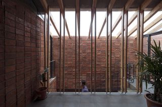 staircase inside brick house by Natura Futura