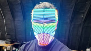 A still from a YouTube video showing "Become Anyone 2.0", a full face changing LED mask