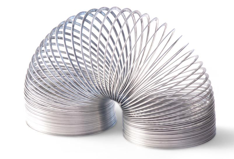 a toy slinky on a white background