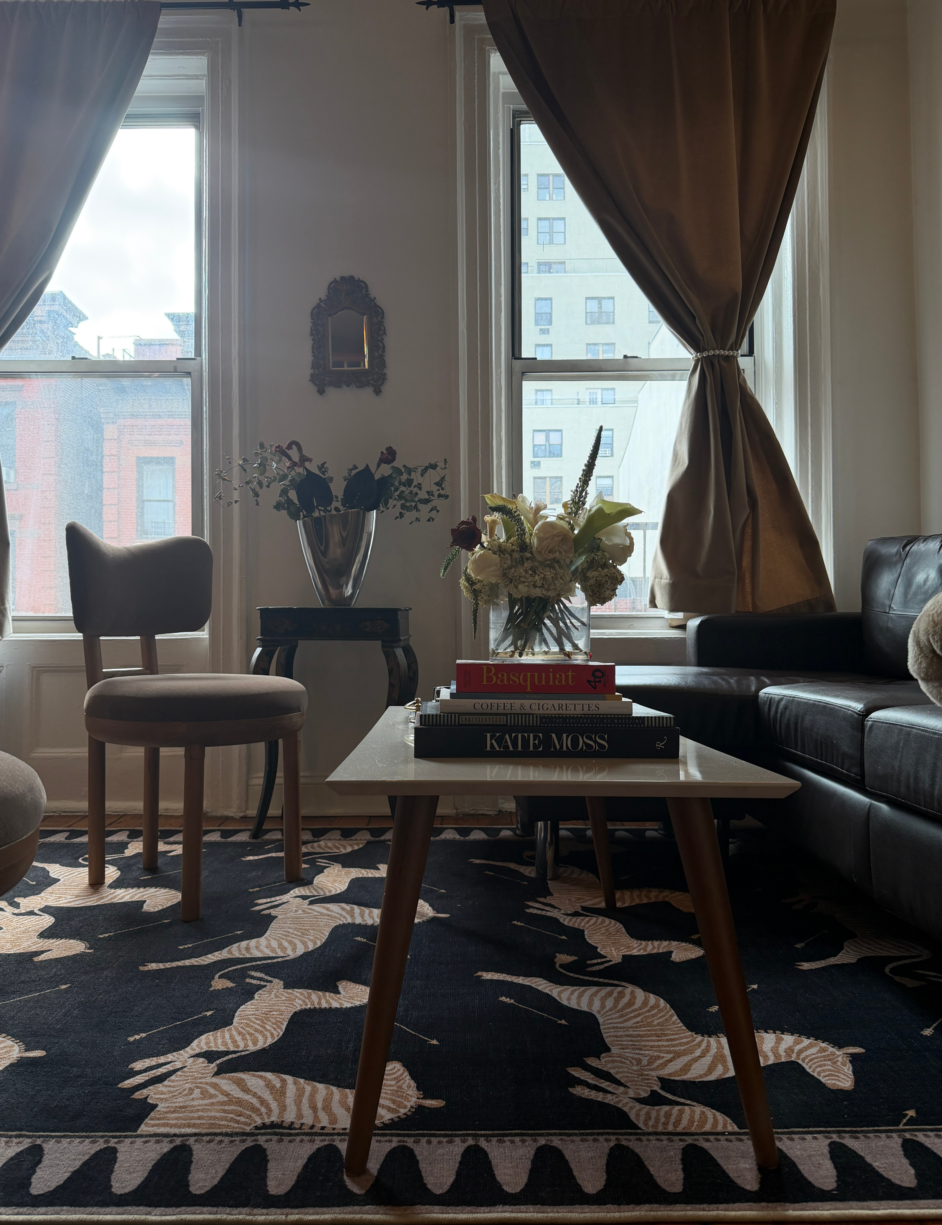 Zebra motif rug pictured in an NYC living room decorated with a mix of new and antique furniture