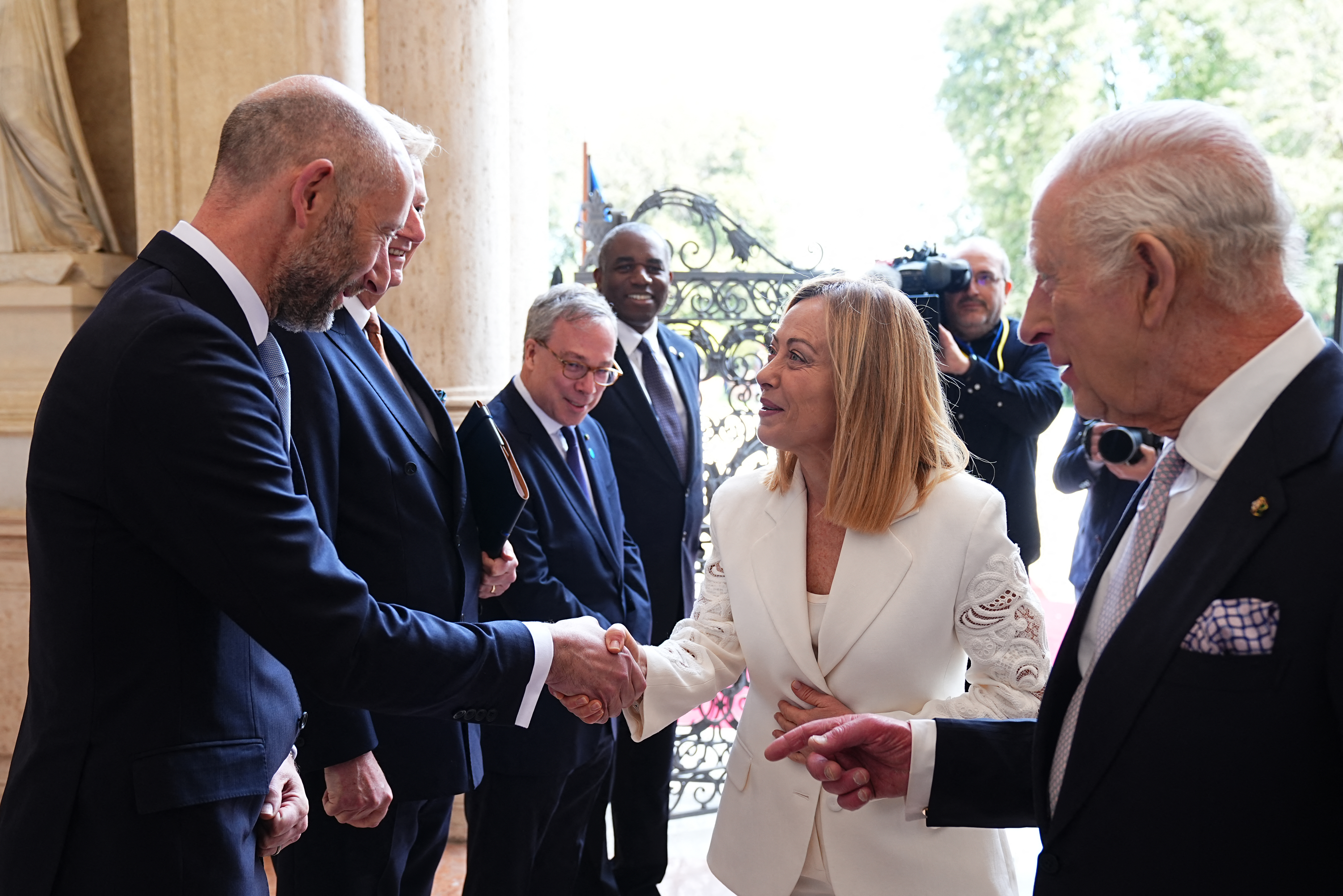 Theo Rycroft shaking hands with Italian Prime Minister Giorgia Meloni as The King watches
