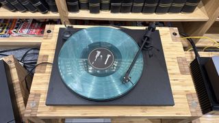 Pro-Ject Primary E turntable on wooden rack
