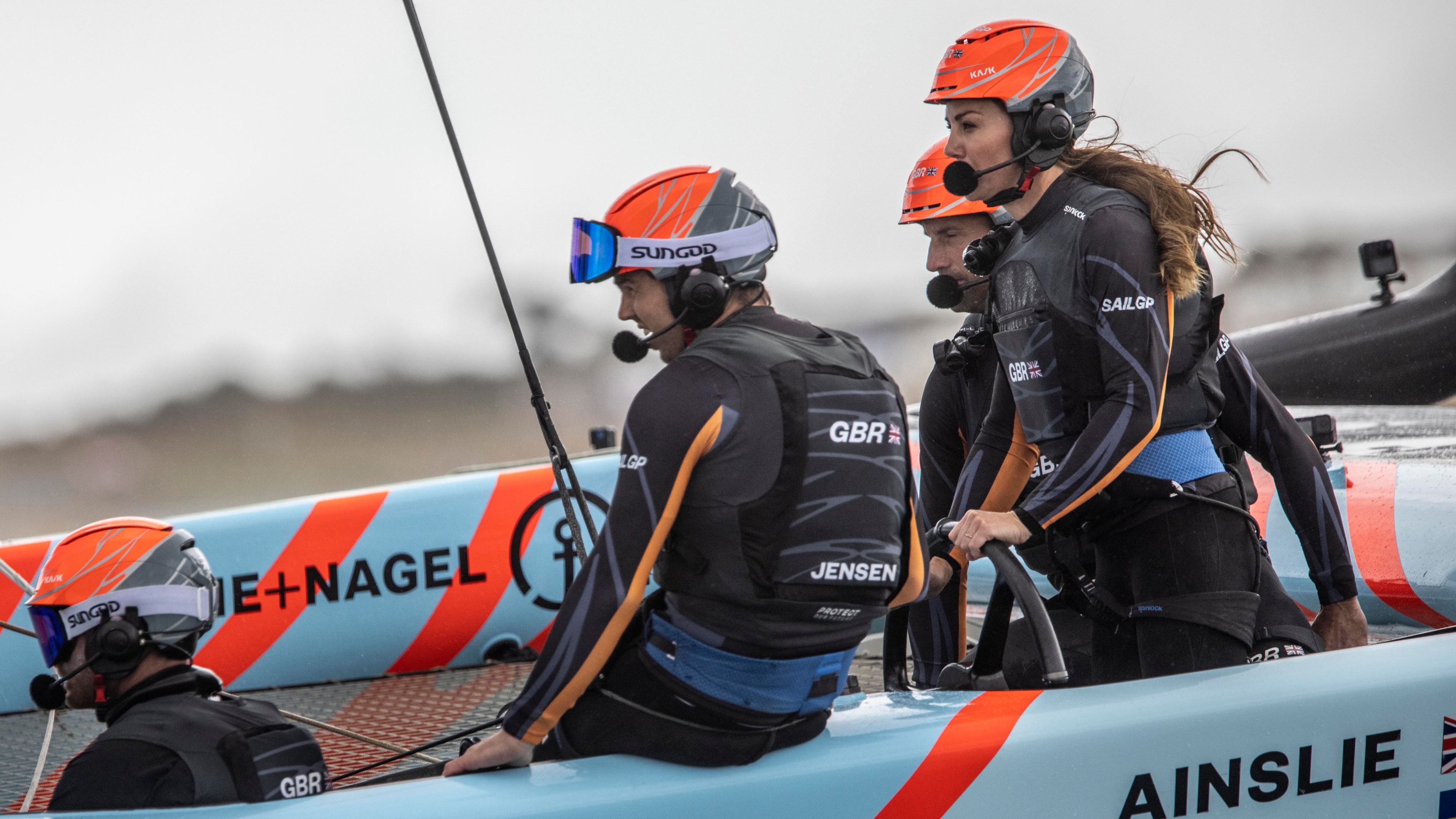 Catherine, Princess of Wales, (R) takes part in a race with the Great Britain SailGP Team at Trinity Pier on July 31, 2022